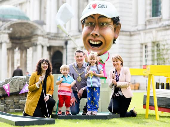 Lord Mayor John Finucane, Lesley-Ann ODonnell, Tourism NI project manager for The Open, and Liz Kerr, chair of Belfast One, get ready for The Great Belfast Tee Off at City Hall with siblings Eliza and Ronan Finnegan.