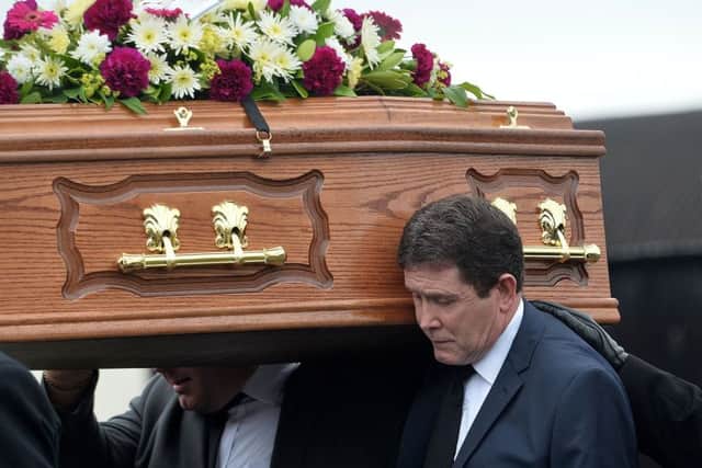 Bea Worton's son Colin carries his mother's coffin today in Markethill. Photo: Colm Lenaghan /Pacemaker