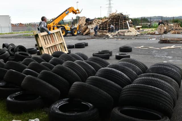 Tyres being removed from the bonfire at Avoniel Leisure Centre in east Belfast. The pyre was later rebuilt.