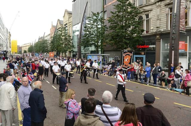 A part of the long Twelfth parade in the heart of Belfast yesterday, on Donegall Place. The march has extraordinary music, particularly the drums, yet there are never that many tourists watching it. July 12 2019