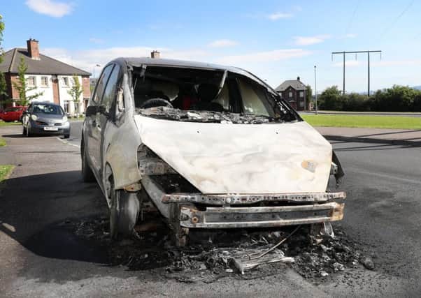 The burnt out car in Dunmurry on Sunday morning