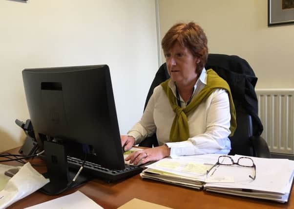 Wilma Erskine, secretary manager of Royal Portrush Golf Club, busy at her computer on the opening day of The Open.
