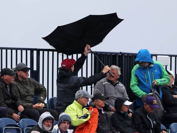 Spectators umbrella turns inside out in the stands during day four of The Open Championship 2019 at Royal Portrush Golf Club.  Niall Carson/PA Wire