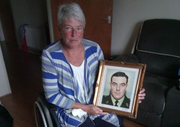 IRA bomb survivor Andrea Brown with a photo of her father Eric, who was murdered by the same group