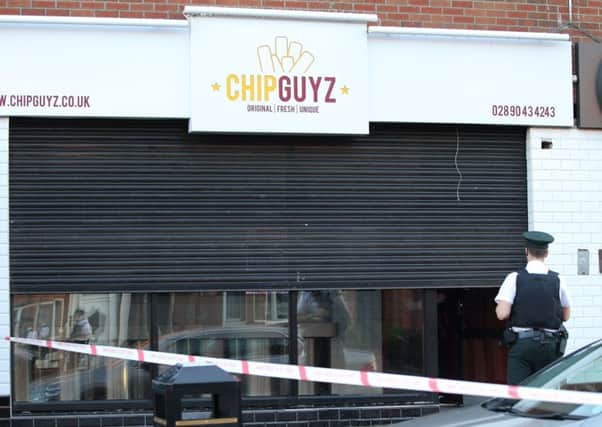A fast food outlet was cordoned off after the shooting in the Springfield Road area