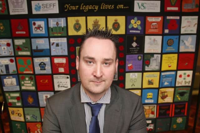 Kenny Donaldson, who is spokesman for Innocent Victims United (IVU), in front of a quilt made by family members from Fermanagh that have lost loved ones through the Troubles. 
Picture Colm O'Reilly, Press Eye