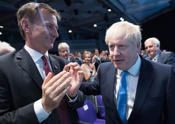(left to right) Jeremy Hunt and Boris Johnson at the Queen Elizabeth II Centre in London as it was announced Mr Johnson is the new Conservative party leader, and will become the next Prime Minister. Photo: Stefan Rousseau/P/A Wire