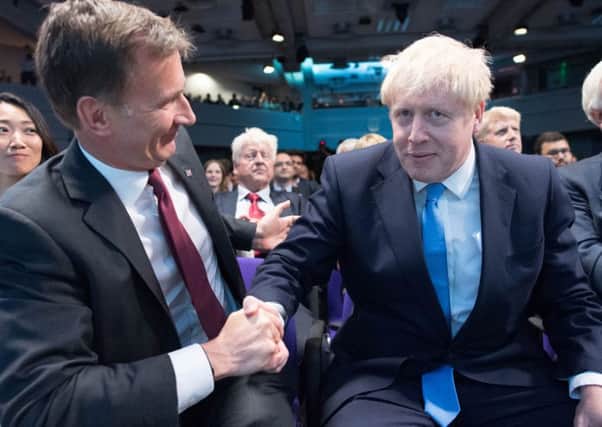 Candidate Jeremy Hunt (left) congratulates Boris Johnson after the result of the Conservative Party leadership election was announced in London
