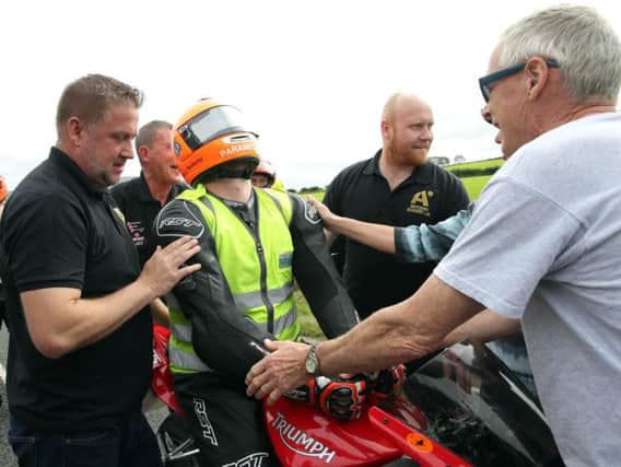 Road racing paramedic Allister MacSorley completed a lap at the Armoy Road Races on Saturday a year on from a crash that left him paralysed from the waist down.
