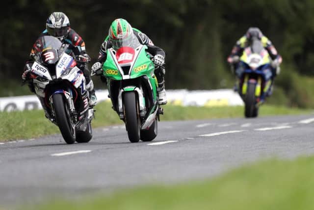 Michael Dunlop battles for the lead of the Open Superbike race with Derek McGee as Derek Sheils gives chase in third. Picture: Stephen Davison/Pacemaker Press.