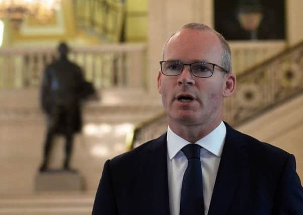 Simon Coveney speaking to the media at Stormont on Friday