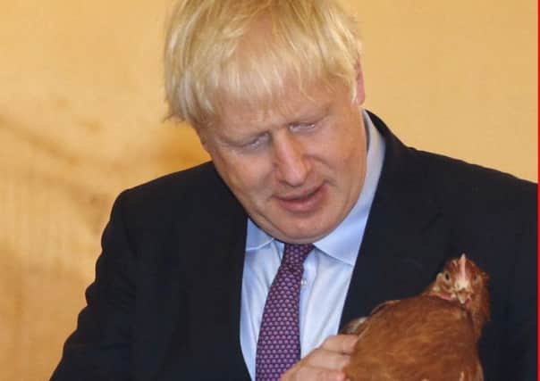Boris Johnson on a visit to a farm in South Wales on Tuesday. His UK tour continues in Northern Ireland on Wednesday