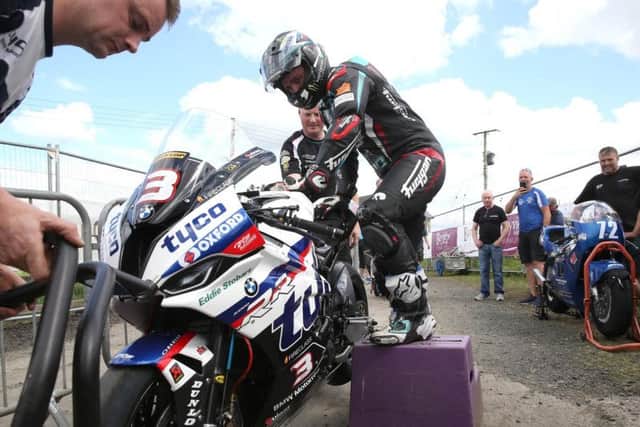 Ballymoney man Michael Dunlop required a set of steps in order to climb onto his Tyco BMW after sustaining injuries including a reported broken pelvis following a crash at the Southern 100. Picture: Stephen Davison/Pacemaker Press.
