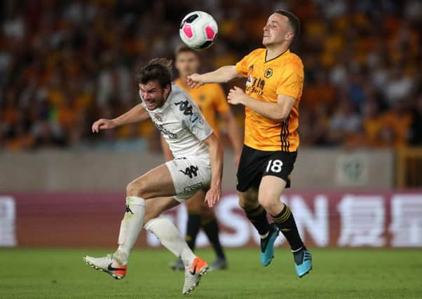 Philip Lowry up against Wolves' Diogo Jota at Molineux in Crusaders' Europa League first-leg clash last week at Molineux. Pic by PA Wire.