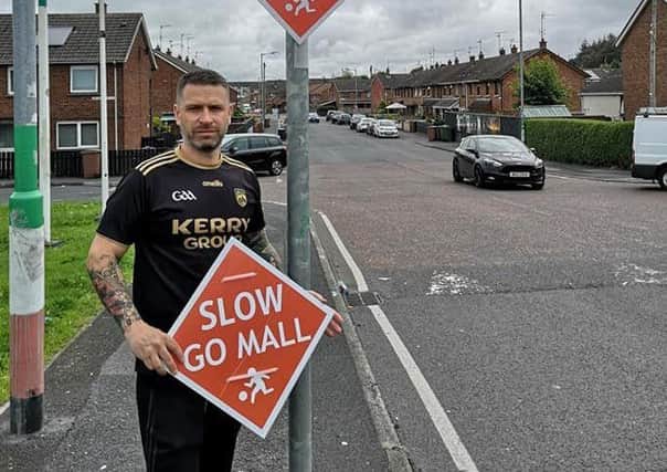 Sinn Fein Councillor Keith Haughian with the bilingual roadsigns the party erected in the Armagh, Banbridge and Craiganon Borough Counil area.
