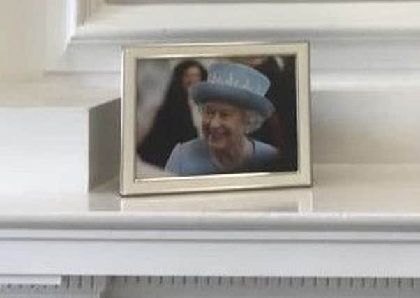 Julian Smith tweeted out this picture of the Queen on a mantelpiece in his Stormont House office
