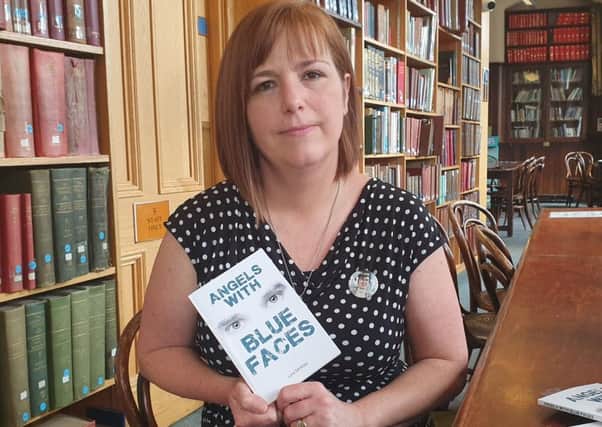 Nichola Corner, the sister of murdered journalist Lyra McKee, with her sister's first book titled Angels with Blue Faces at the Linen Hall library in Belfast today, Friday August 2.  Photo: Rebecca Black/PA Wire