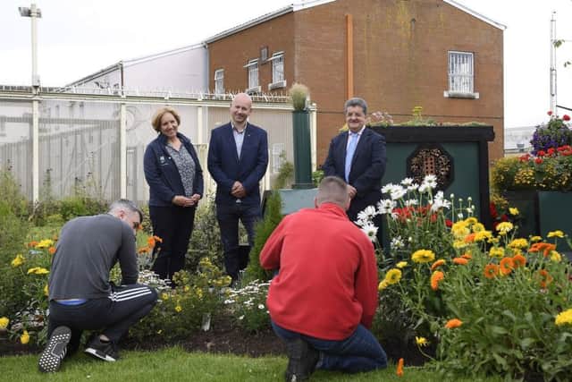 In the garden with prisoners at work (from left) are Tammi Peek of the National Trust, Richard Whiting of Belfast Met and Ronnie Armour of NIPS
