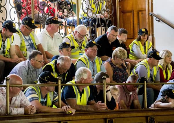 Harland and Wolff workers and supporters in the public gallery of Belfast City Hall listen to their colleagues addressing the council during emergency meeting to discuss the threat of the closure to the shipyard. Photo credit: Liam McBurney/PA Wire