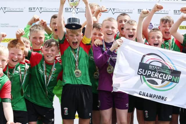 Glentoran captain Lucas Miskimmin lifts the cup after defeating Dungannon United Youth in the STATSports SuperCupNI Minor Final. Picture by Brian Little/PressEye