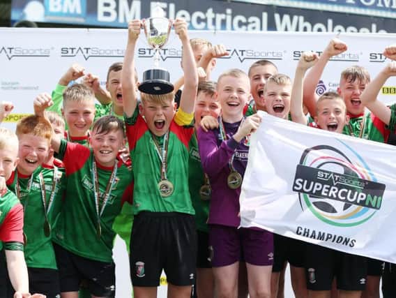 Glentoran captain Lucas Miskimmin lifts the cup after defeating Dungannon United Youth in the STATSports SuperCupNI Minor Final. Picture by Brian Little/PressEye