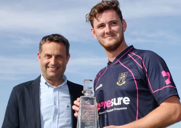 Mark Adair with his Man-of-the-Match award from Shane Matthews (regional managing director, Gallagher UK). Pic by Ian Johnston/Cricket Europe