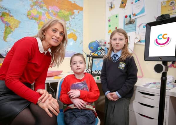 Charlie Craig with his mother, Cliodhna and sister, Nancy at the launch of the Children's Cancer Unit Charity's robotics project.  Photo by Matt Mackey / Press Eye