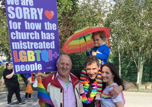 Coalisland rector Rev Andrew Rawding took his apology placard to Newry  Gay pride parade. Also pictured is his wife Loveday, daughter and a friend they met on the day.