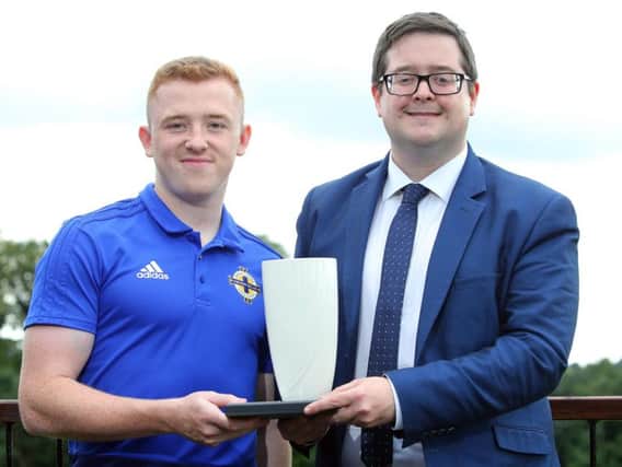 NIFWA committee man Keith Bailie presents Linfield's Shayne Lavery with the Belleek trophy for Player of the Month.