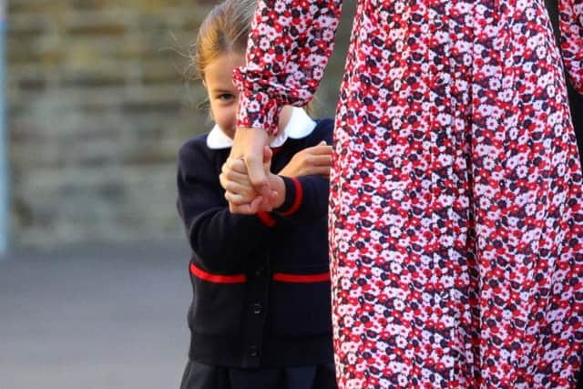 Princess Charlotte holds the hand of her mother, the Duchess of Cambridge, as she arrives for her first day of school at Thomas's Battersea in London.