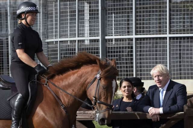 Prime Minister Boris Johnson with Home Secretary Priti Patel during a visit to West Yorkshire, where he gave a speech about Brexit as he stood in front of lines of new police recruits.