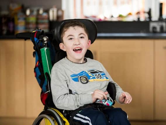 Jack McCrystal who has a neuro-muscular disorder which means he is fed through a tube and uses a wheelchair, at home in Draperstown in Co Londonderry.