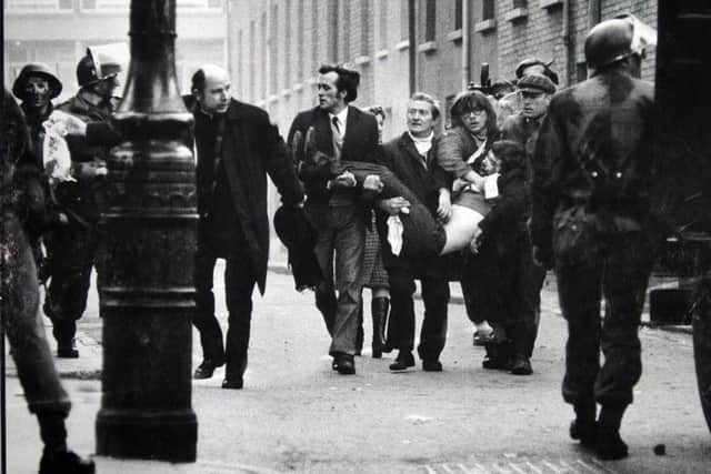 Father Edward Daly and others try to get medical aid for one of those shot by the Parachute Regiment on Bloody Sunday. Stanley Matchett