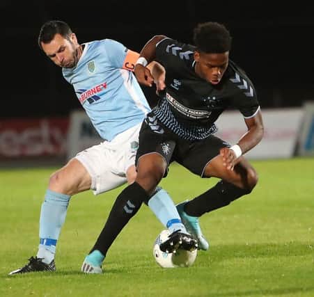 Ballymena United's Jim Ervin (left) up against Rangers Colts' Adedapo Mebude. Pic by Pacemaker.