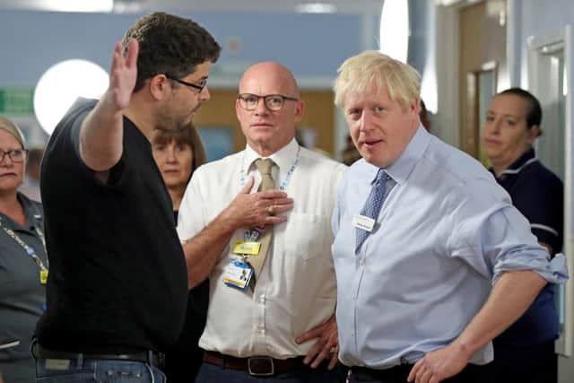 The father of a young girl, who is being treated in the Acorn childrens' ward, expresses his anger over hospital waiting times to Prime Minister Boris Johnson during his visit to Whipps Cross University Hospital in Leytonstone, east London