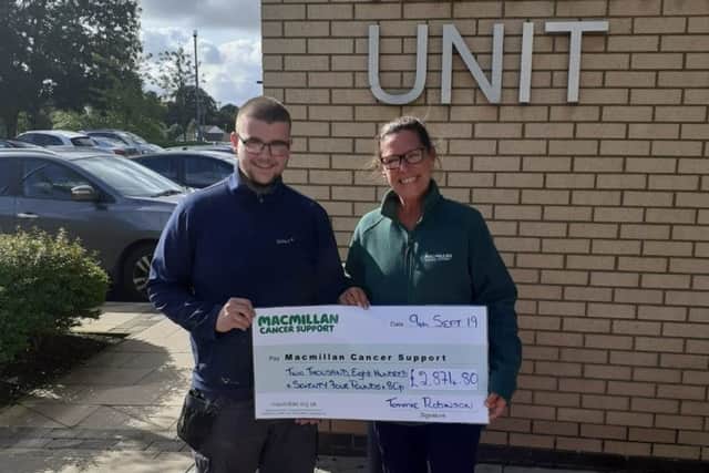 Tommie pictured donating the money to Macmillan Cancer Support.