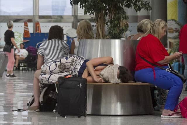 British passengers wait for news on cancelled Thomas Cook flights at Palma de Mallorca airport on Monday Sept. 23, 2019. (AP Photo/Francisco Ubilla)