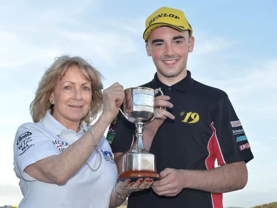 Teenage racer Aaron Clifford, pictured here with Lee Wood after winning the David Wood Memorial Trophy at Bishopscourt in 2016.