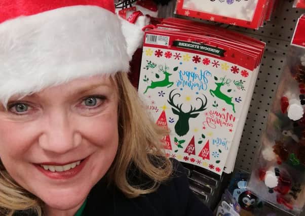 Reporter Helen McGurk beside the Christmas display in Poundland