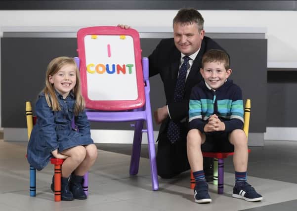 Dr David Marshall, director of census and population statistics at NISRA, with Abigail and Isaac Morrow