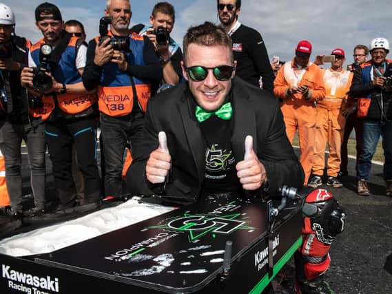 Jonathan Rea donned a Kawasaki-green dickie bow and jacket as he toasted his fifth successive World Superbike title success on Sunday at Magny-Cours in France.