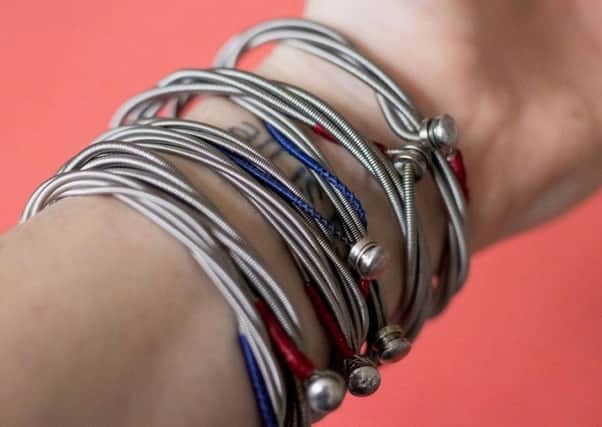 Some of the bracelets designed by Ash bass player Mark Hamilton using guitar strings from his friends in Snow Patrol
