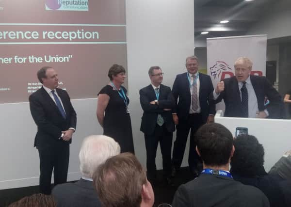 Nigel Dodds MP, Arlene Foster MLA and Sir Jeffrey Donaldson MP listen to the prime minister, Boris Johnson, addressing the DUP drinks reception at the Conservative Party conference on Tuesday October 1 2019