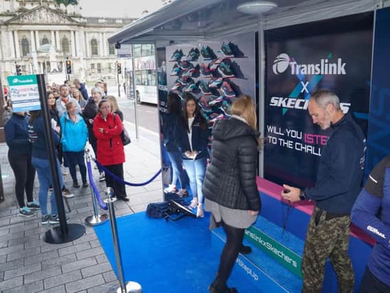 Translink passengers queued up to take part in the step challenge to be rewarded with a free pair of Skechers trainers. Photo by Aaron McCracken