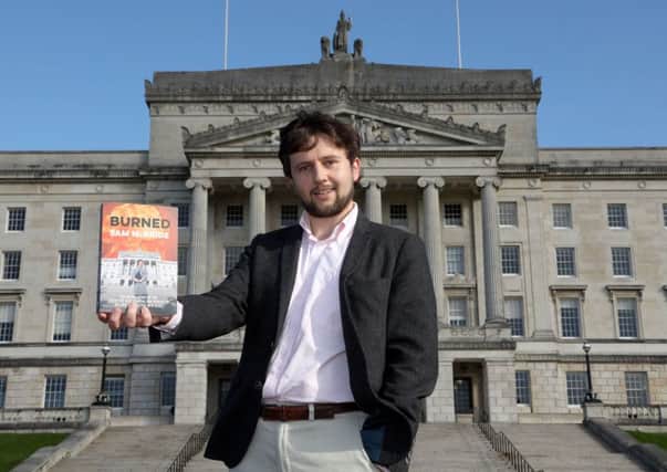 Journalist and author Sam McBride with his new book 'Burned' outside Parliament Buildings, Stormont.
 Photo: Laura Davison/Pacemaker Press