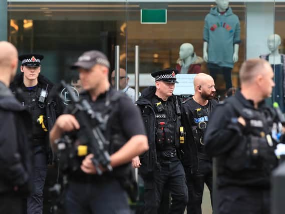 Armed police officers outside the Arndale Centre in Manchester where at least five people have been treated after a stabbing incident. (Photo: Peter Byrne/P.A. Wire)