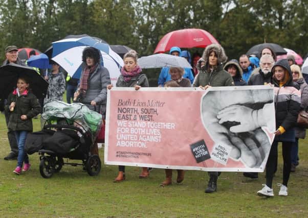 Anti-abortion campaigners marched through a cold and wet Falls Park in west Belfast yesterday. The Both Lives Matter protestors carried a banner saying North, South, East and West. We stand together for both lives, united against abortion