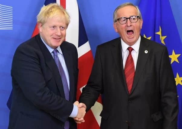 Prime Minister Boris Johnson and Jean-Claude Juncker, President of the European Commission, ahead of the opening sessions of the European Council summit at EU headquarters in Brussels on Thursday. (Photo: P.A. Wire/Stefan Rousseau)