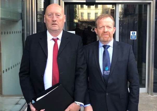 John Sproule and Ken Funston deliver a file to the Attorney General's office calling for a new inquest into the murder of John's brother, Ian.