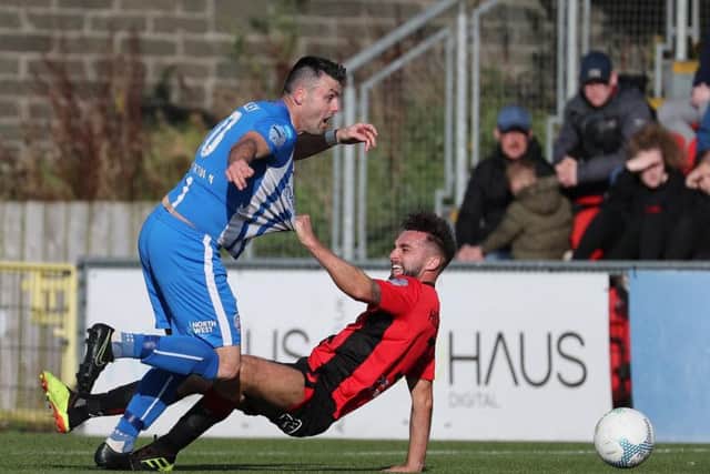Chris Hegarty brings down Eoin Bradley for Coleraine's first penalty